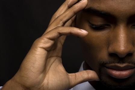 man holding head pensively