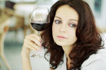 sad woman with a glass of red wine